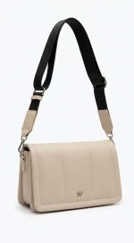 Sac bandoulière de couleur écru avec sangle large ajustable et design minimaliste porté sur fond blanc.
