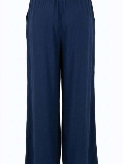 Pantalon fluide bleu marine à coupe large avec taille élastique, vu de dos sur fond neutre.