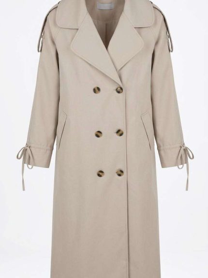 Trench-coat beige pour femme avec boutons et liens aux manches, style chic et classique pour la mi-saison chez Orkidia Fashion.